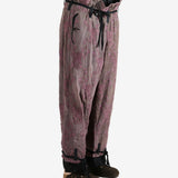 Purple pants worn by a person, showing the pants's fit