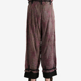 Purple pants worn by a person, showing the pants's fit