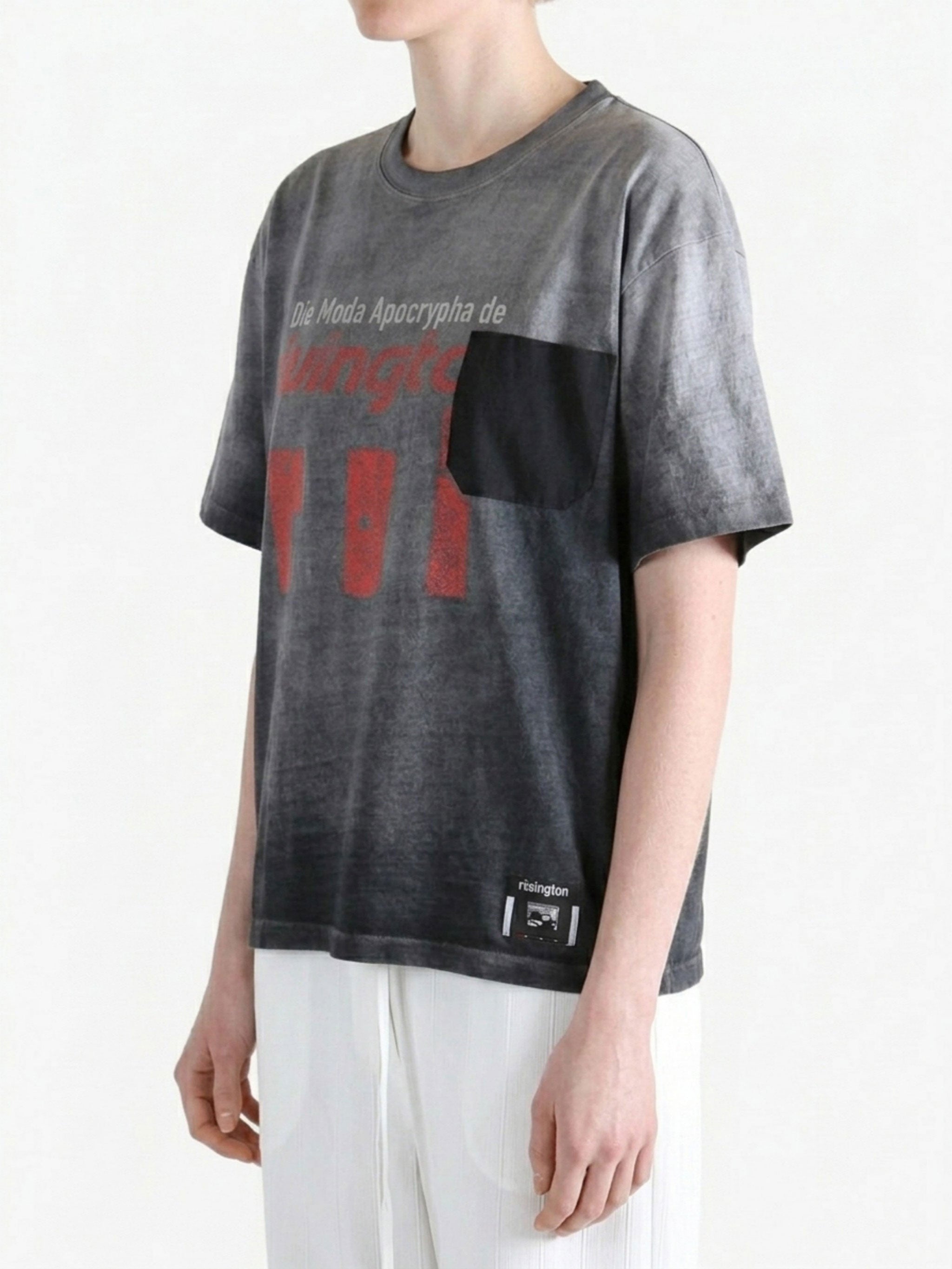 Grey t-shirt worn by a person, side view