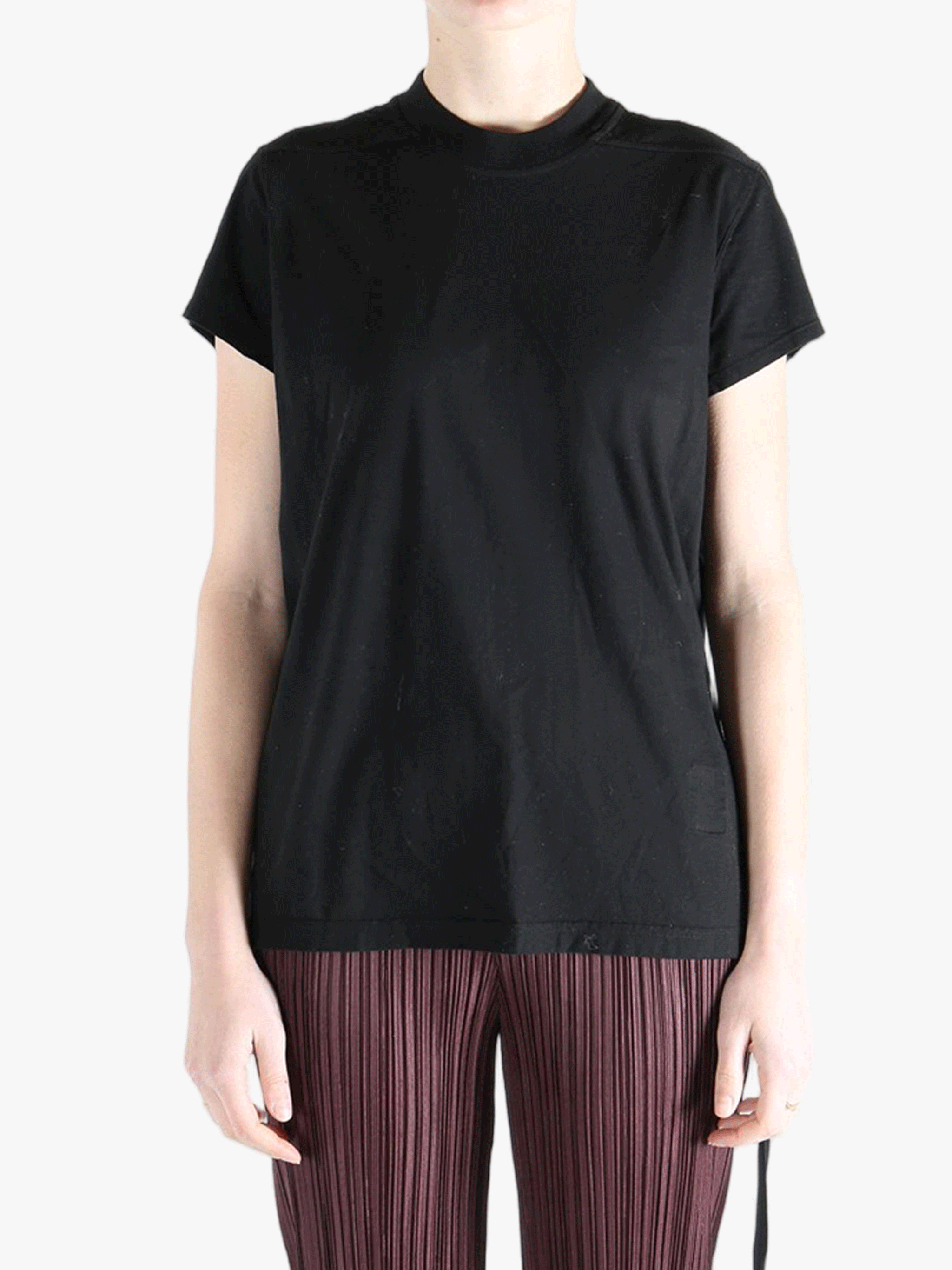 Black shirt worn by a person, showing the shirt's fit