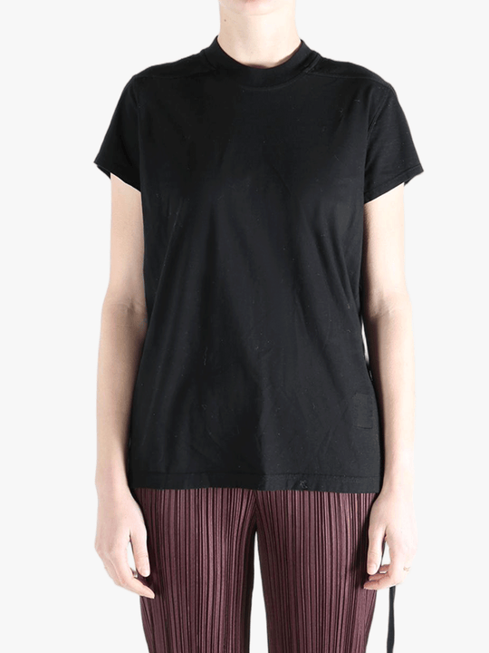 Black shirt worn by a person, showing the shirt's fit