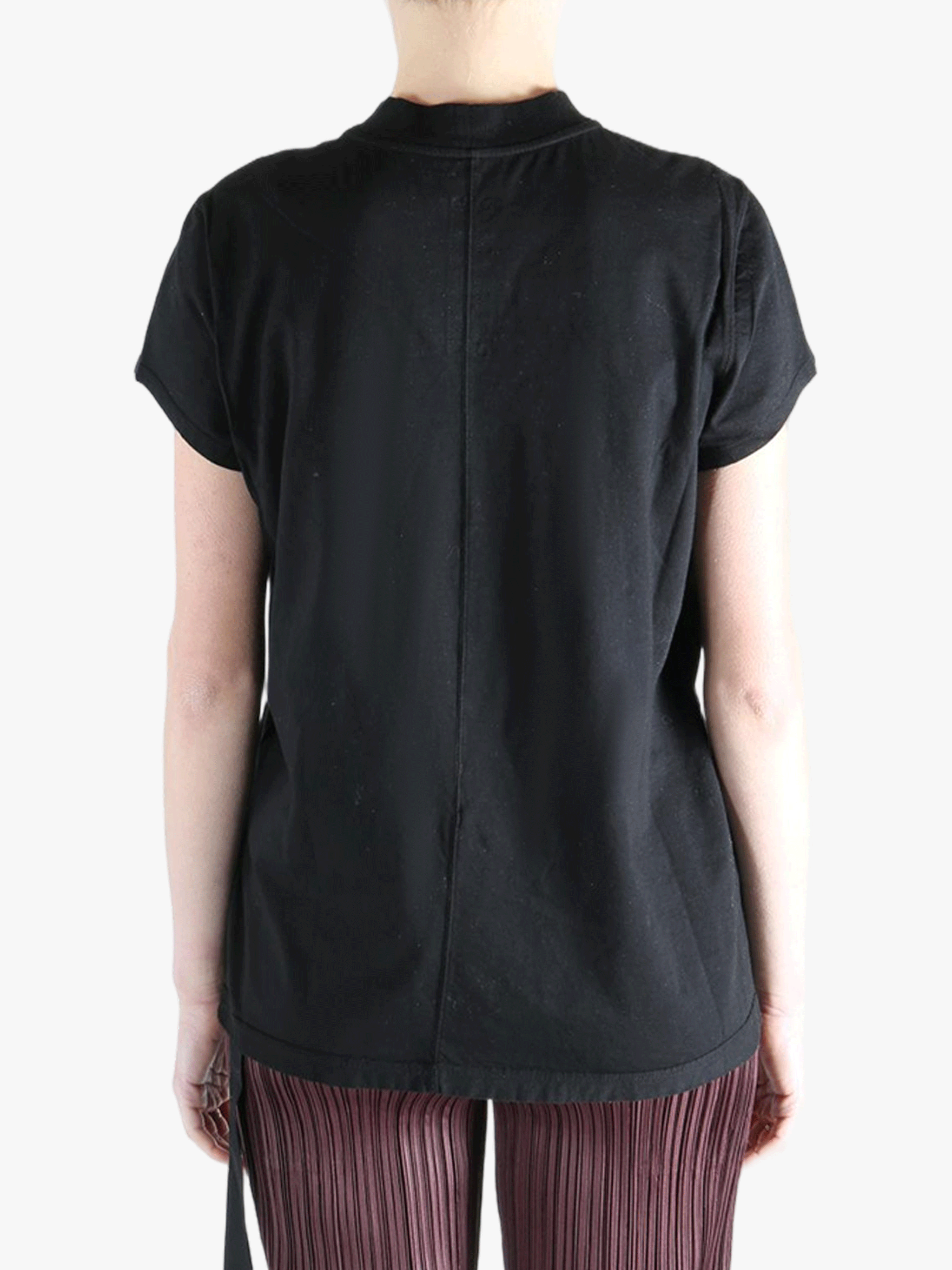 Black shirt worn by a person, showing the shirt's fit