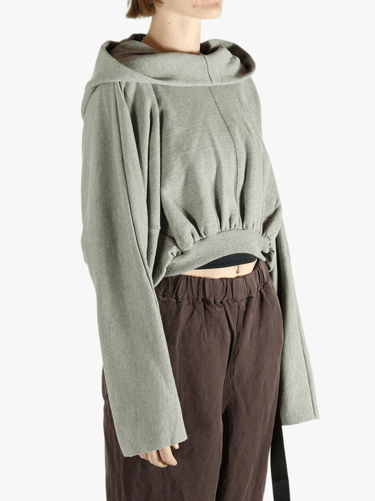 Grey top worn by a person, showing the top's fit