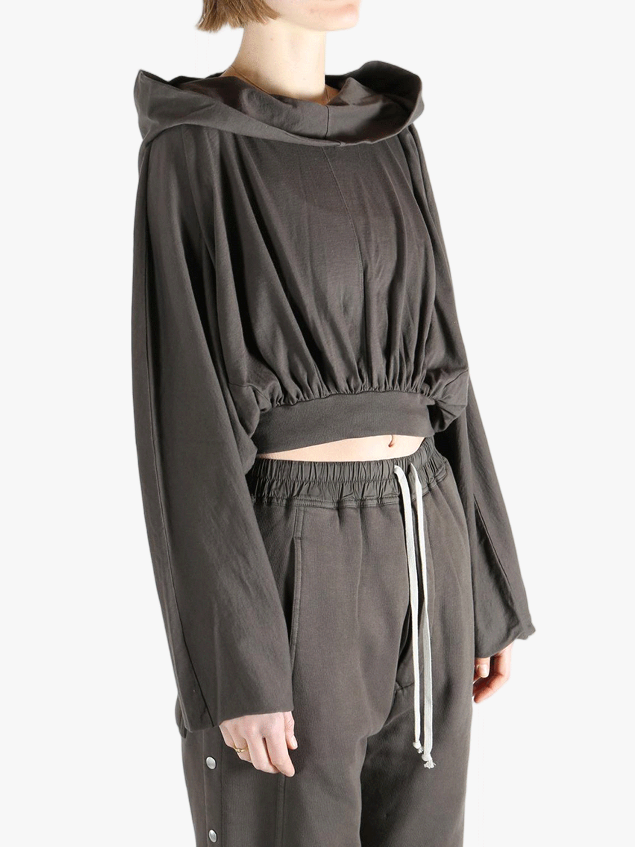 Brown top worn by a person, showing the top's fit