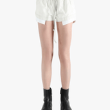 White shorts worn by a person, showing the shorts's fit