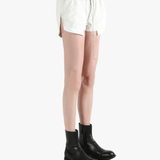 White shorts worn by a person, showing the shorts's fit