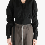 Black jacket worn by a person, showing the jacket's fit