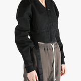 Black jacket worn by a person, showing the jacket's fit