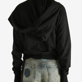 black jacket worn by a person, showing the jacket fit