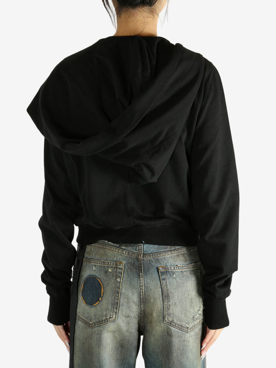 black jacket worn by a person, showing the jacket fit