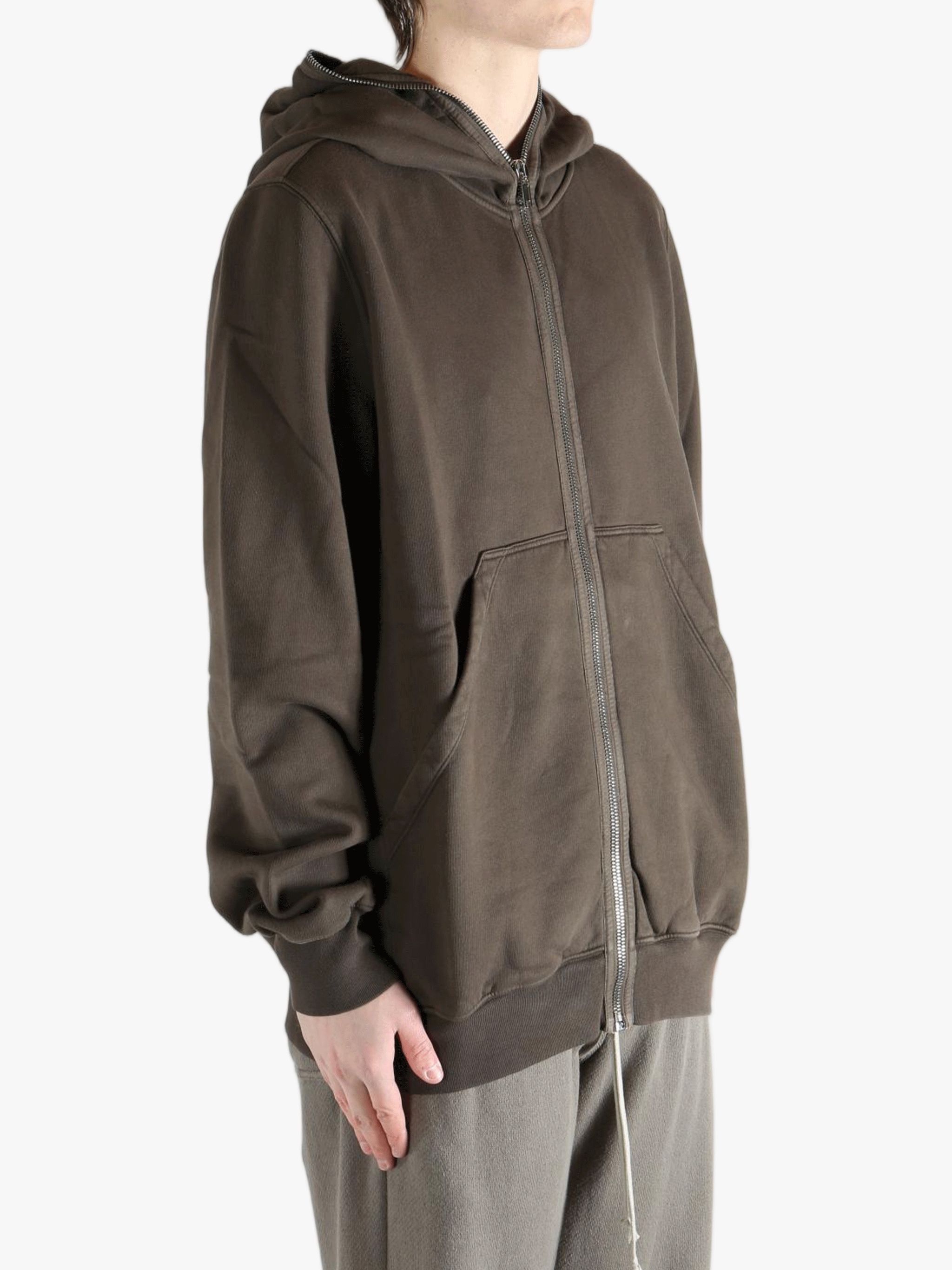 Brown hoodie worn by a person, showing the hoodie's fit