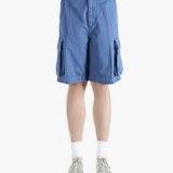 Blue shorts worn by a person,showing texture of the cotton fabric.