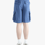 Blue cargo shorts worn by a person,showing texture of the cotton fabric.