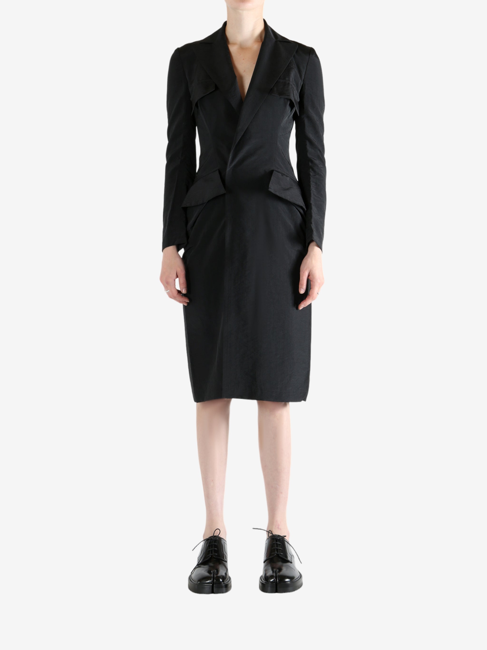 black dress worn by a person, showing the dress fit