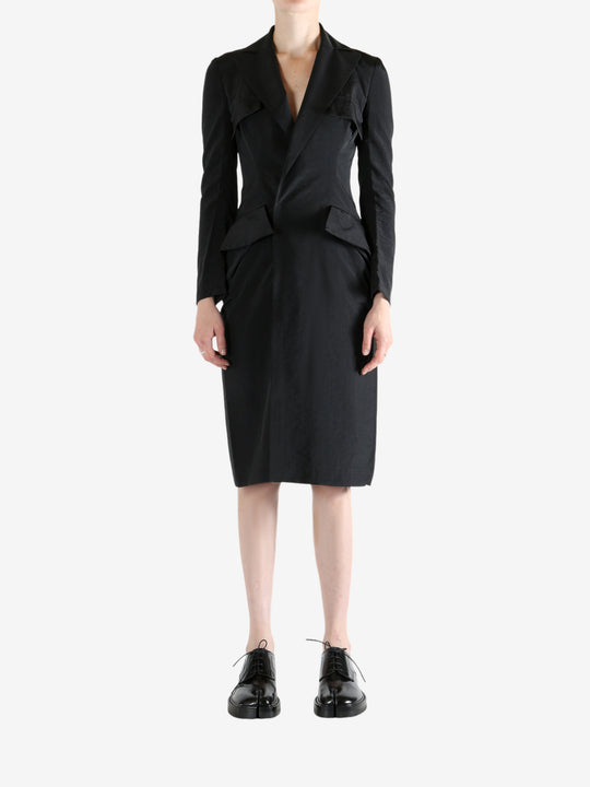 black dress worn by a person, showing the dress fit