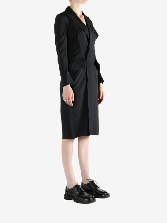 black dress worn by a person, showing the dress fit