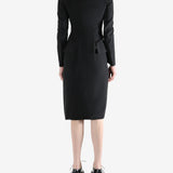 black dress worn by a person, showing the dress fit