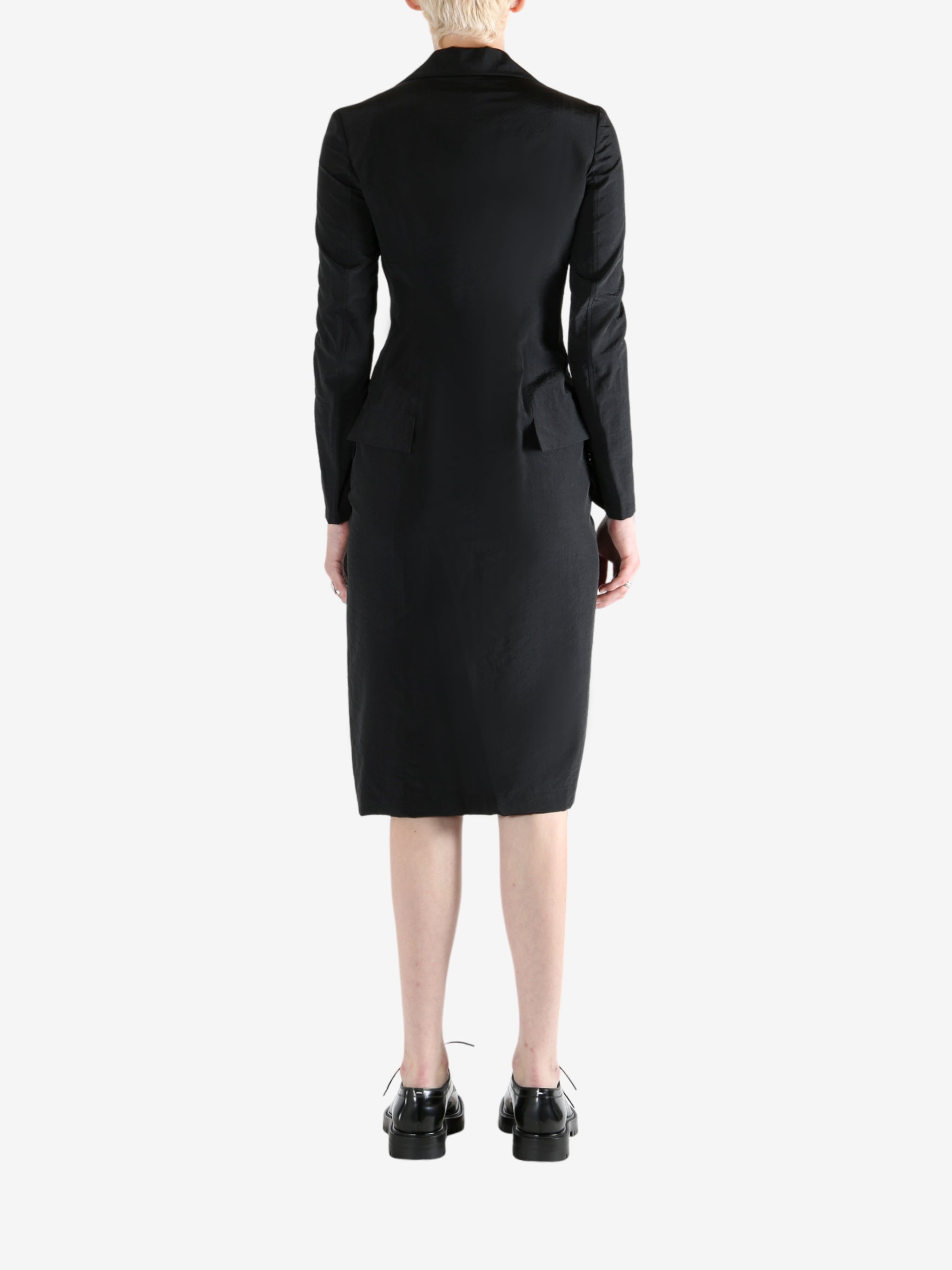 black dress worn by a person, showing the dress fit