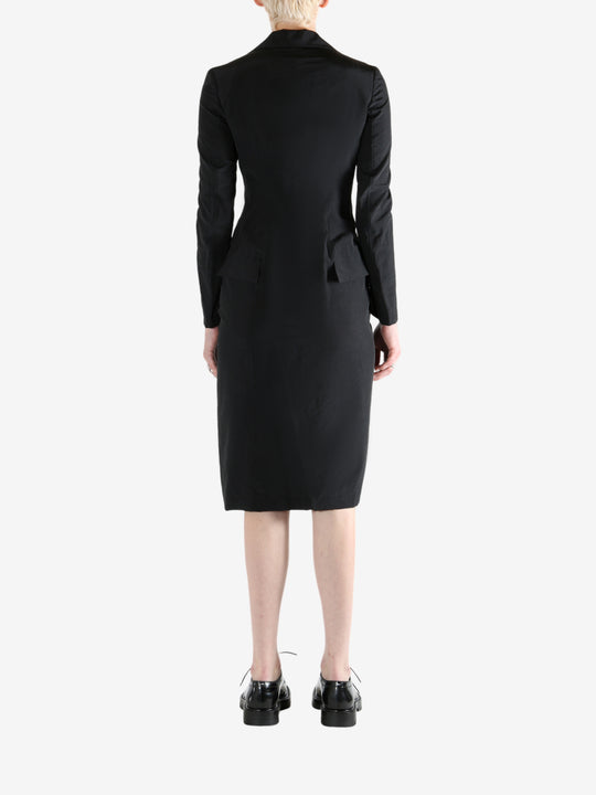 black dress worn by a person, showing the dress fit