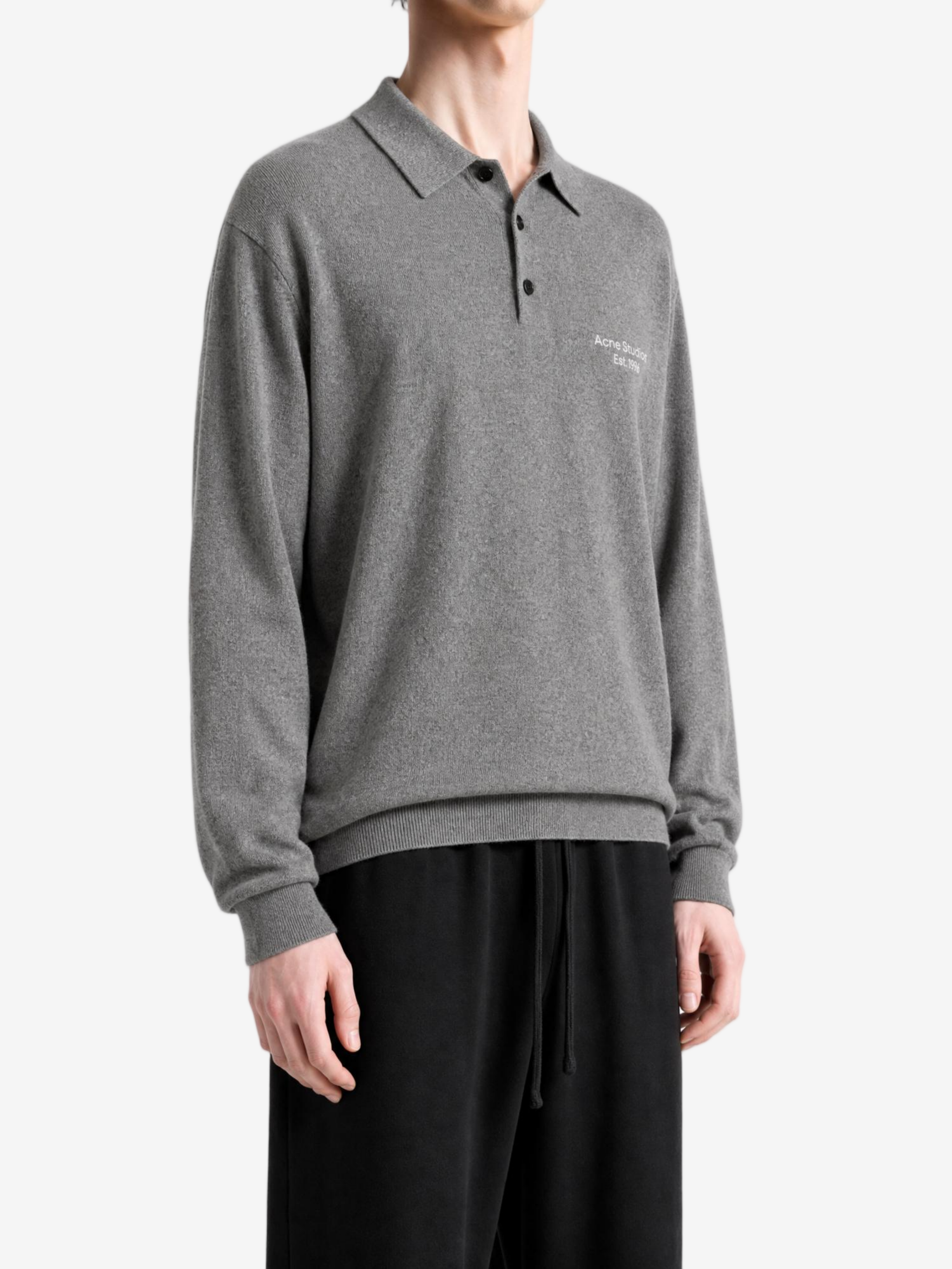 Grey knitwear worn by a person, showing the knitwear fit