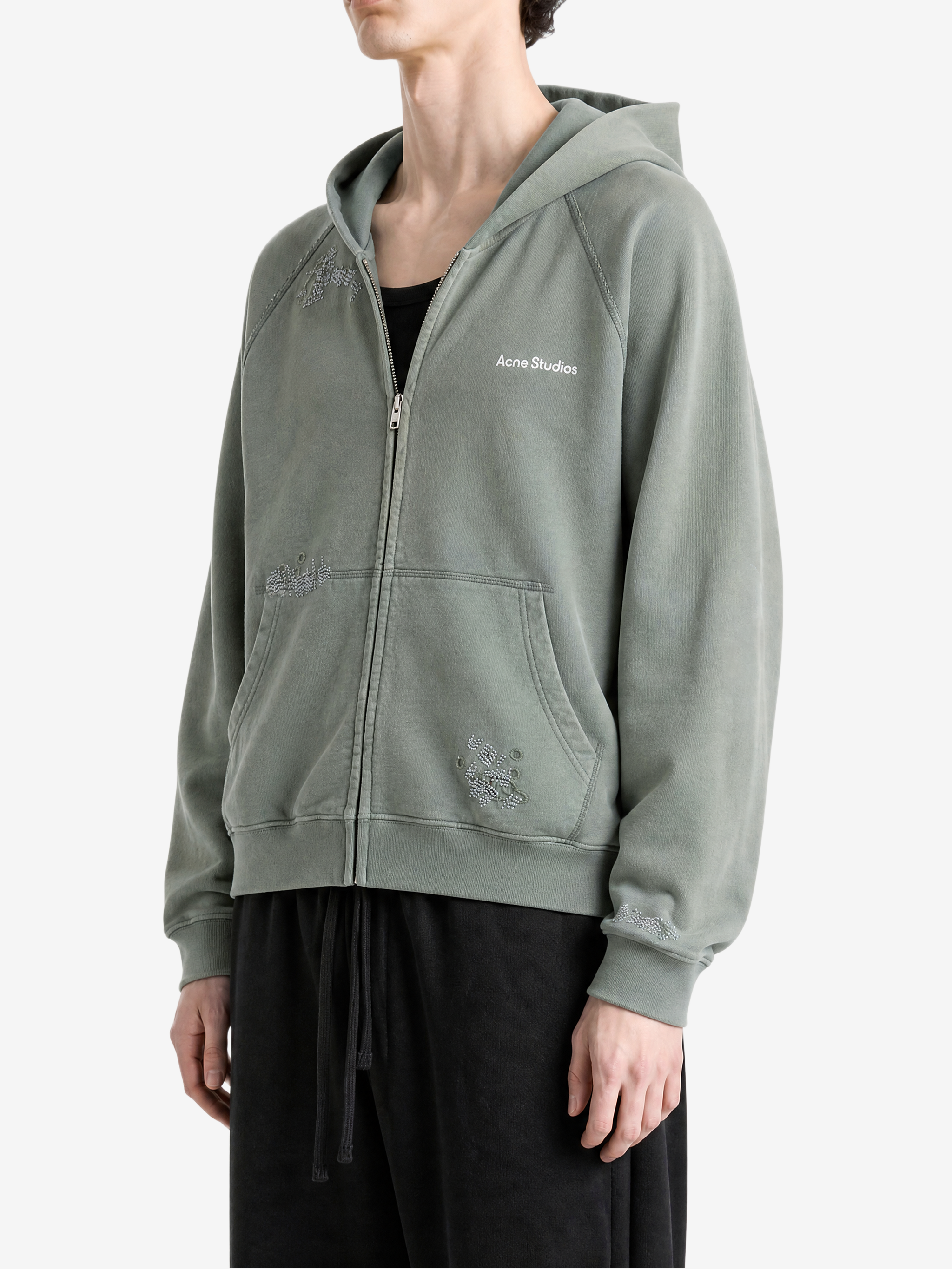 Green hoodie worn by a person, showing the hoodie fit