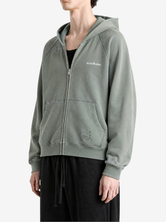 Green hoodie worn by a person, showing the hoodie fit