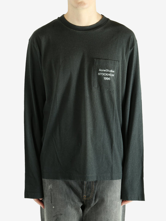 Black long-sleeve shirt worn by a person, showing the shirt fit