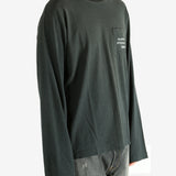 Black long-sleeve shirt worn by a person, showing the shirt fit