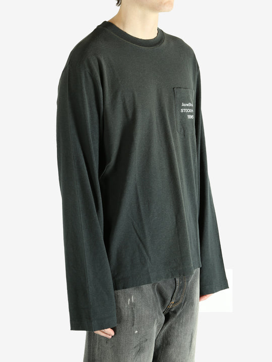 Black long-sleeve shirt worn by a person, showing the shirt fit