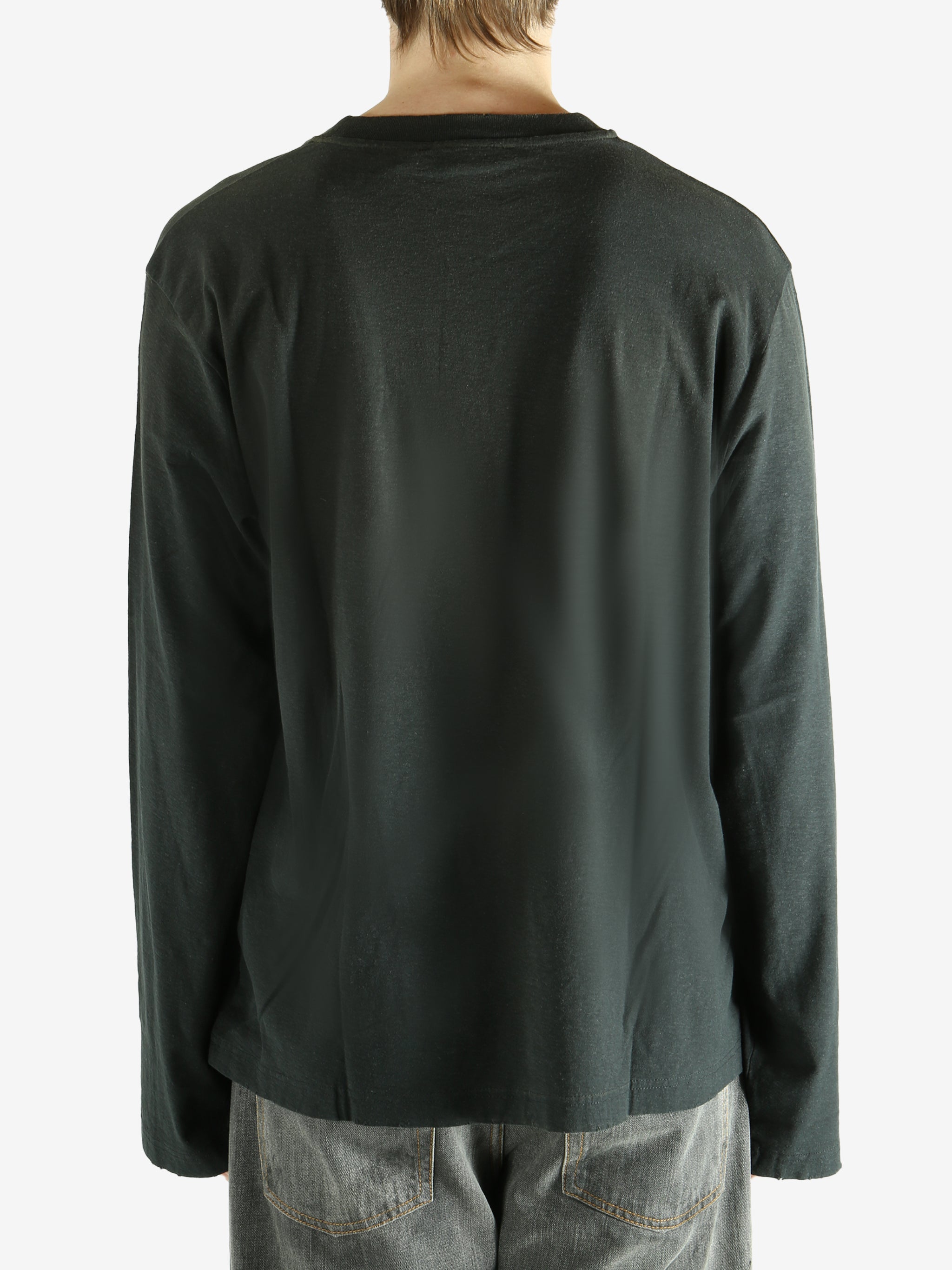 Black long-sleeve shirt worn by a person, showing the shirt fit