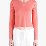 red tee worn by a person, showing the tee fit