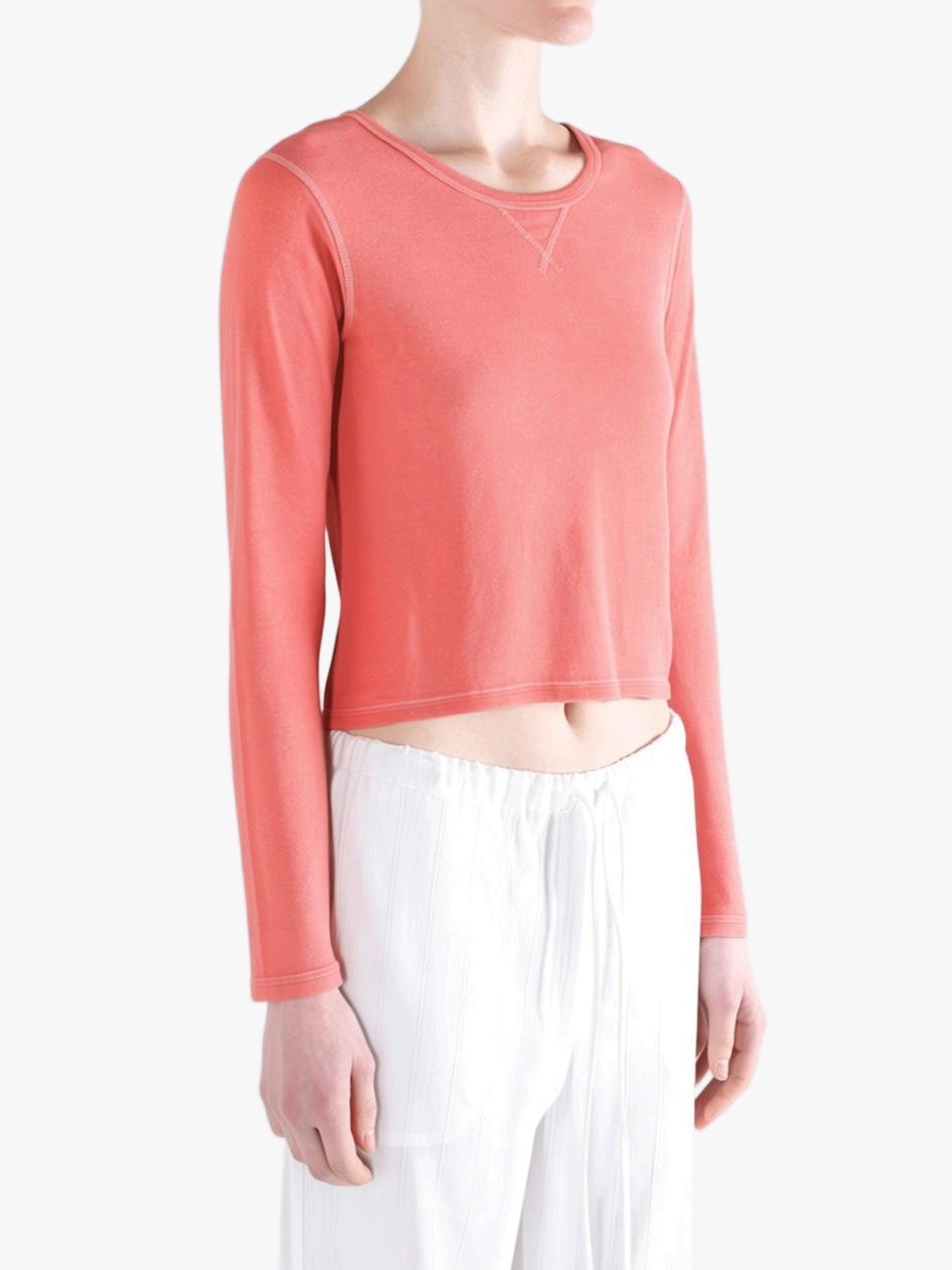 red tee worn by a person, showing the tee fit