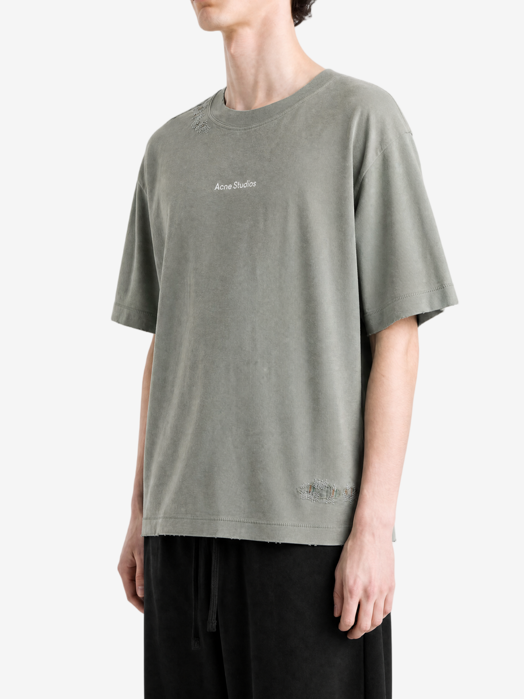 Green t-shirt worn by a person, showing the t-shirt fit