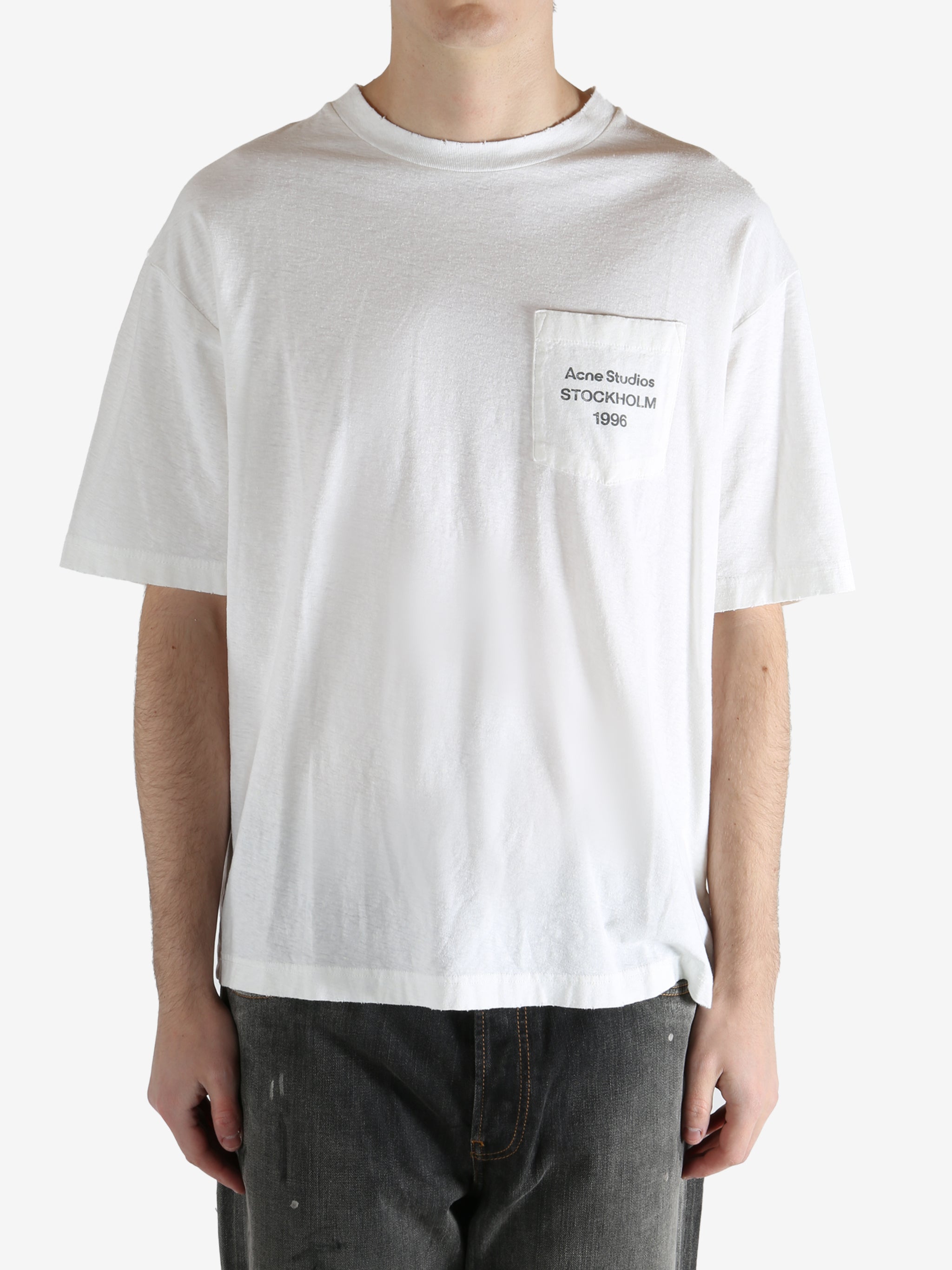 White t-shirt worn by a person, showing the shirt's fit