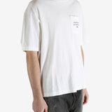 White t-shirt worn by a person, showing the shirt's fit