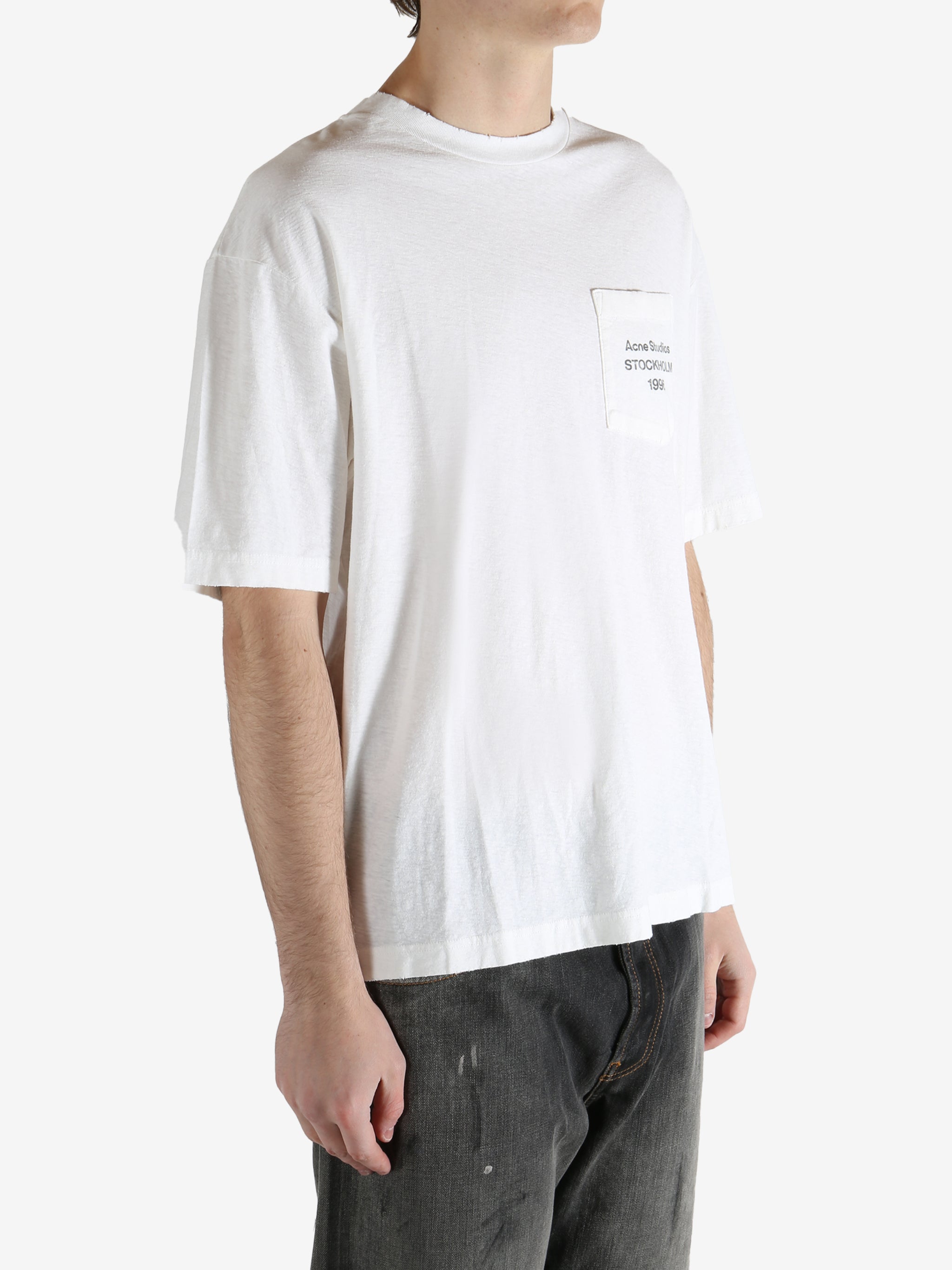 White t-shirt worn by a person, showing the shirt's fit