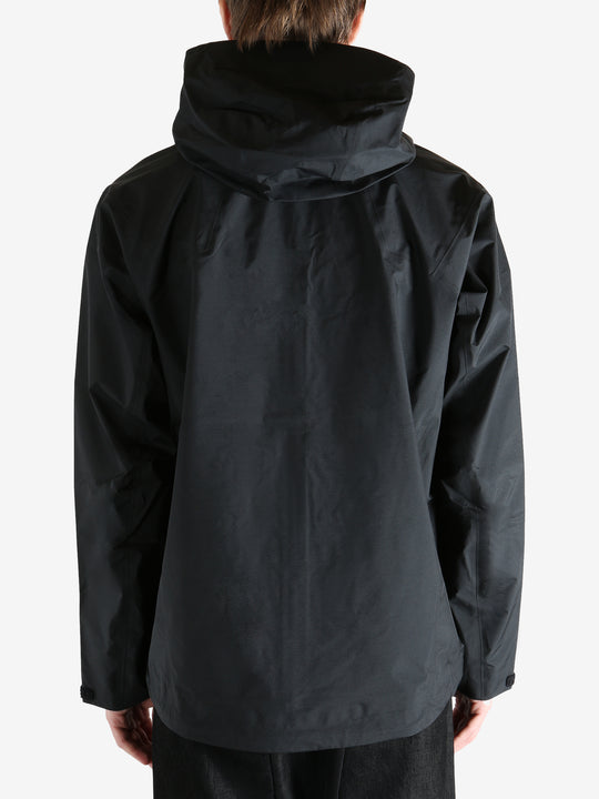 Black jacket worn by a person, showing the jacket fit