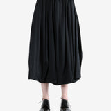 black skirt worn by a person, showing the skirt fit