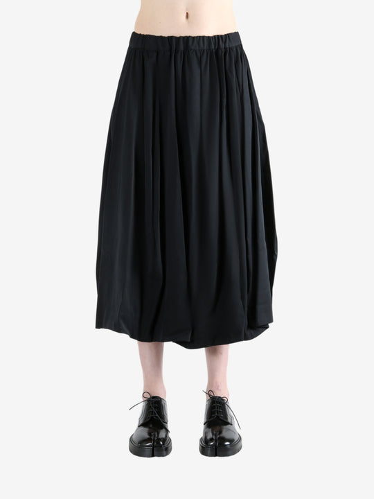 black skirt worn by a person, showing the skirt fit