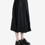 black skirt worn by a person, showing the skirt fit