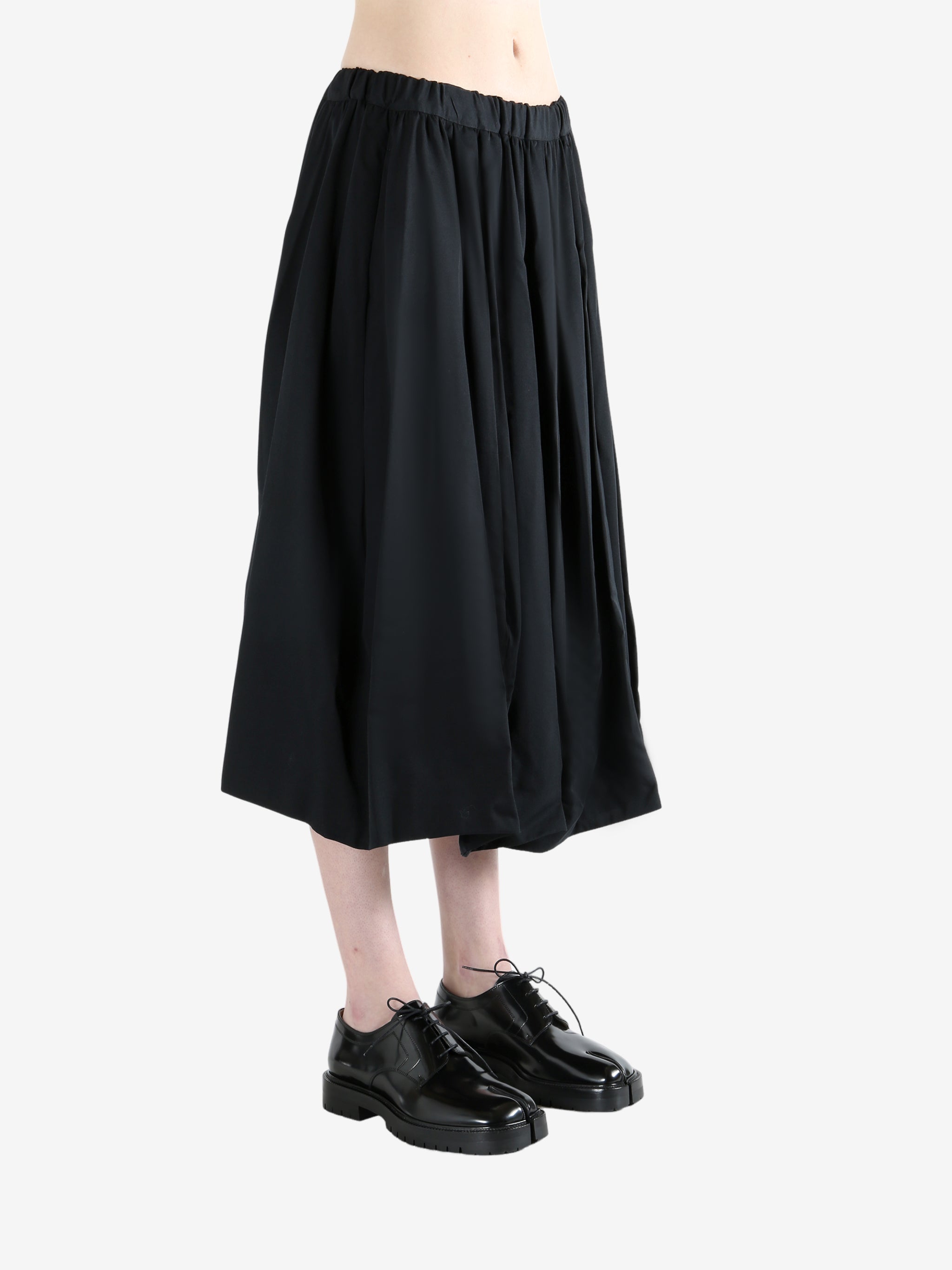 black skirt worn by a person, showing the skirt fit