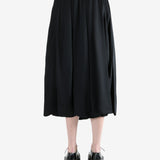 black skirt worn by a person, showing the skirt fit