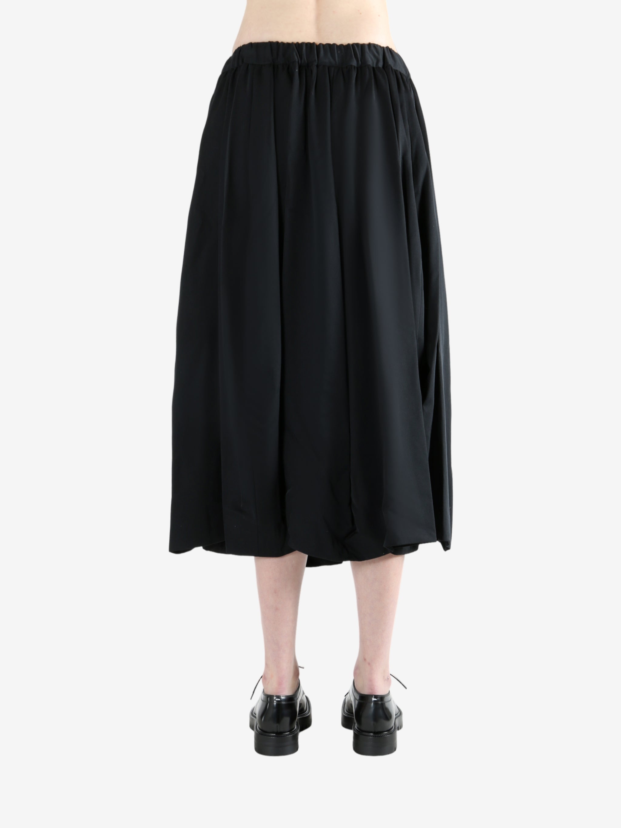 black skirt worn by a person, showing the skirt fit