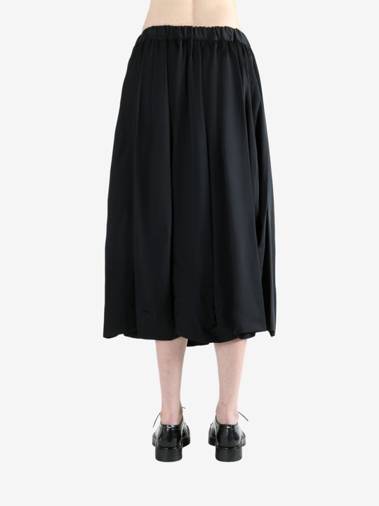 black skirt worn by a person, showing the skirt fit