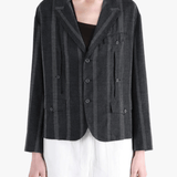 Black jacket-coat worn by a person, showing the jacket-coat's fit