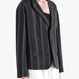 Black jacket-coat worn by a person, showing the jacket-coat's fit