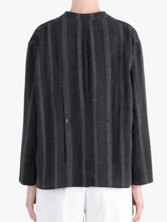 Black jacket-coat worn by a person, showing the jacket-coat's fit