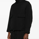 Black coat  worn by a person, showing the coat's fit