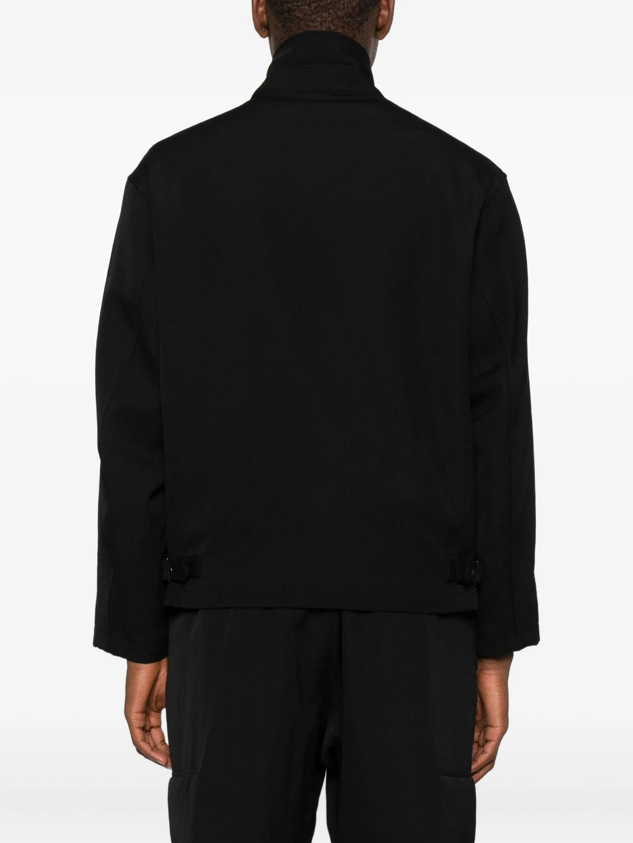 Black coat  worn by a person, showing the coat's fit