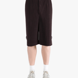 Black pants worn by a person, showing the pant's fit
